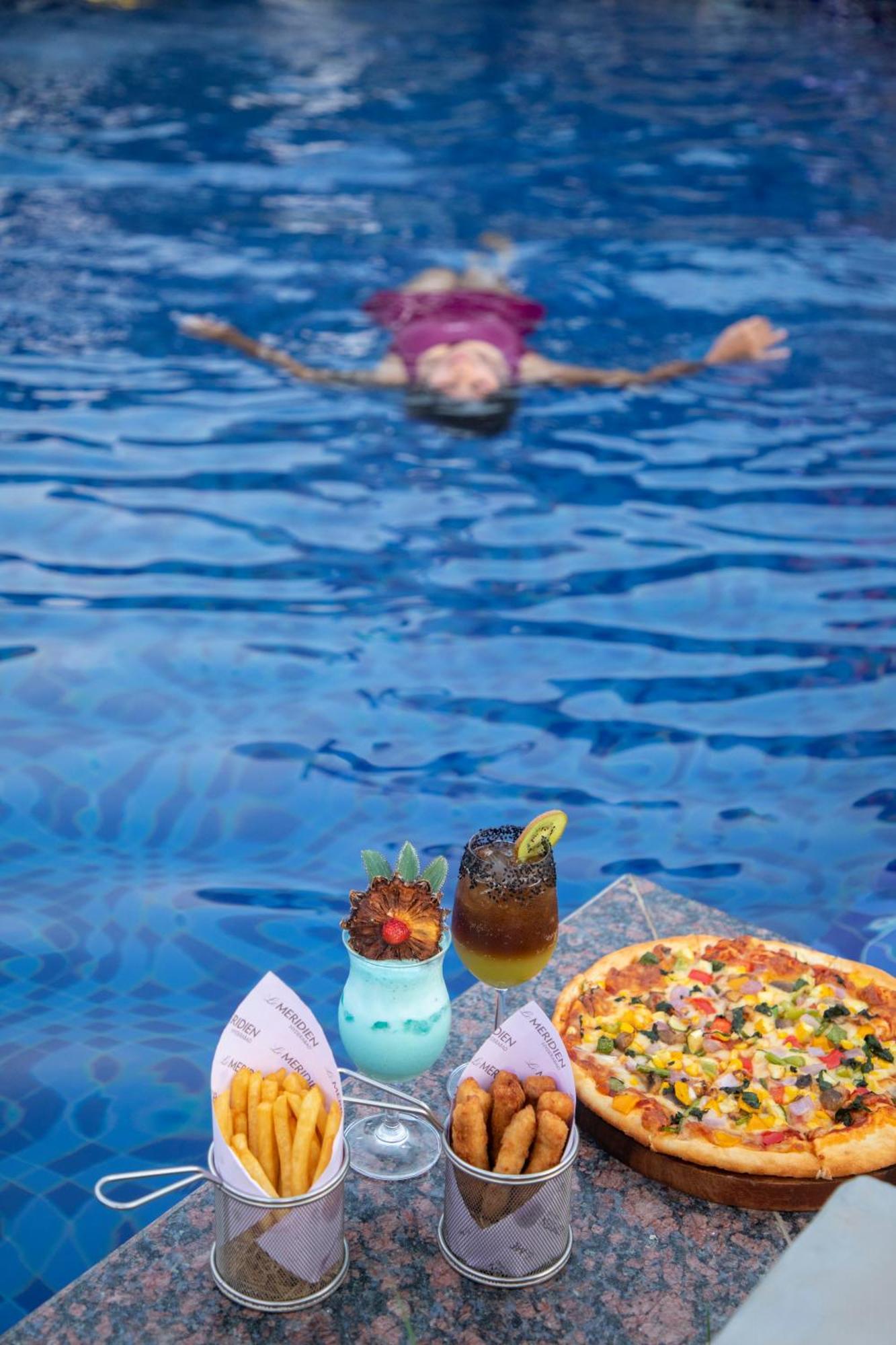 Le Meridien Hyderabad Exterior foto A woman floating in the Dead Sea